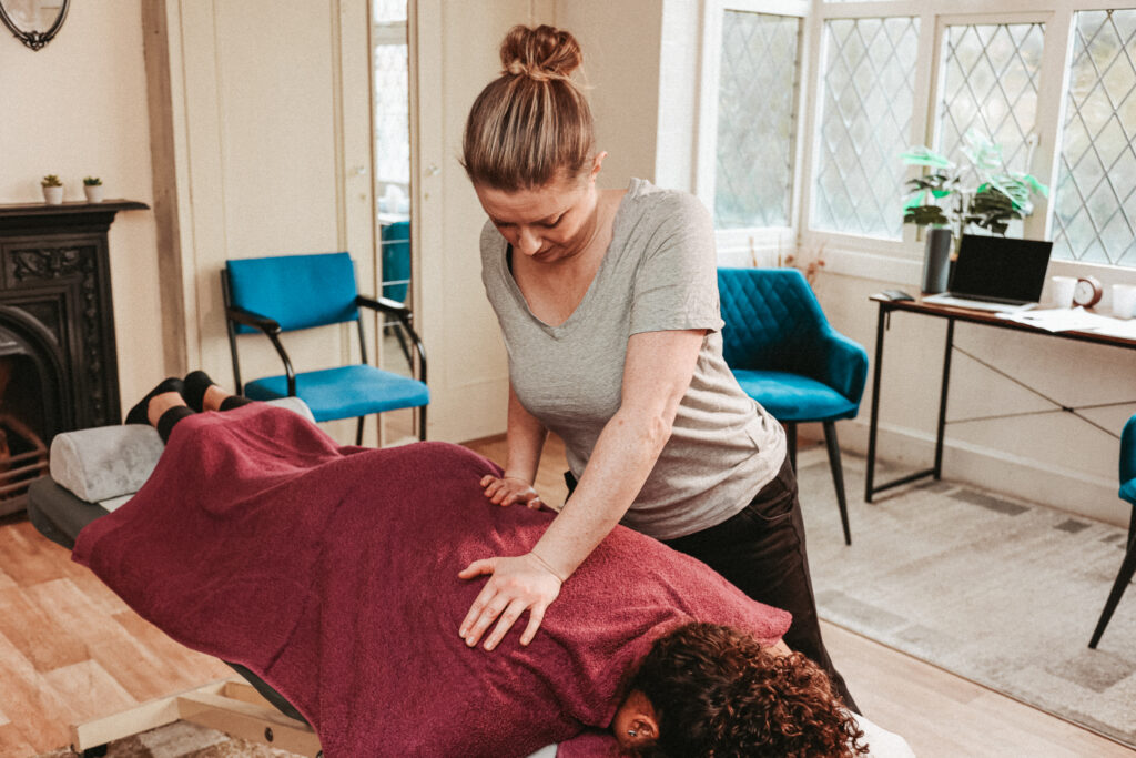 Gemma in her role as a Body Specialist massaging a client's back