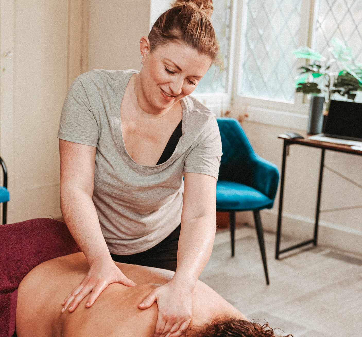 Voice and Body Specialist Gemma Boaden starting soft tissue massage on a client's back